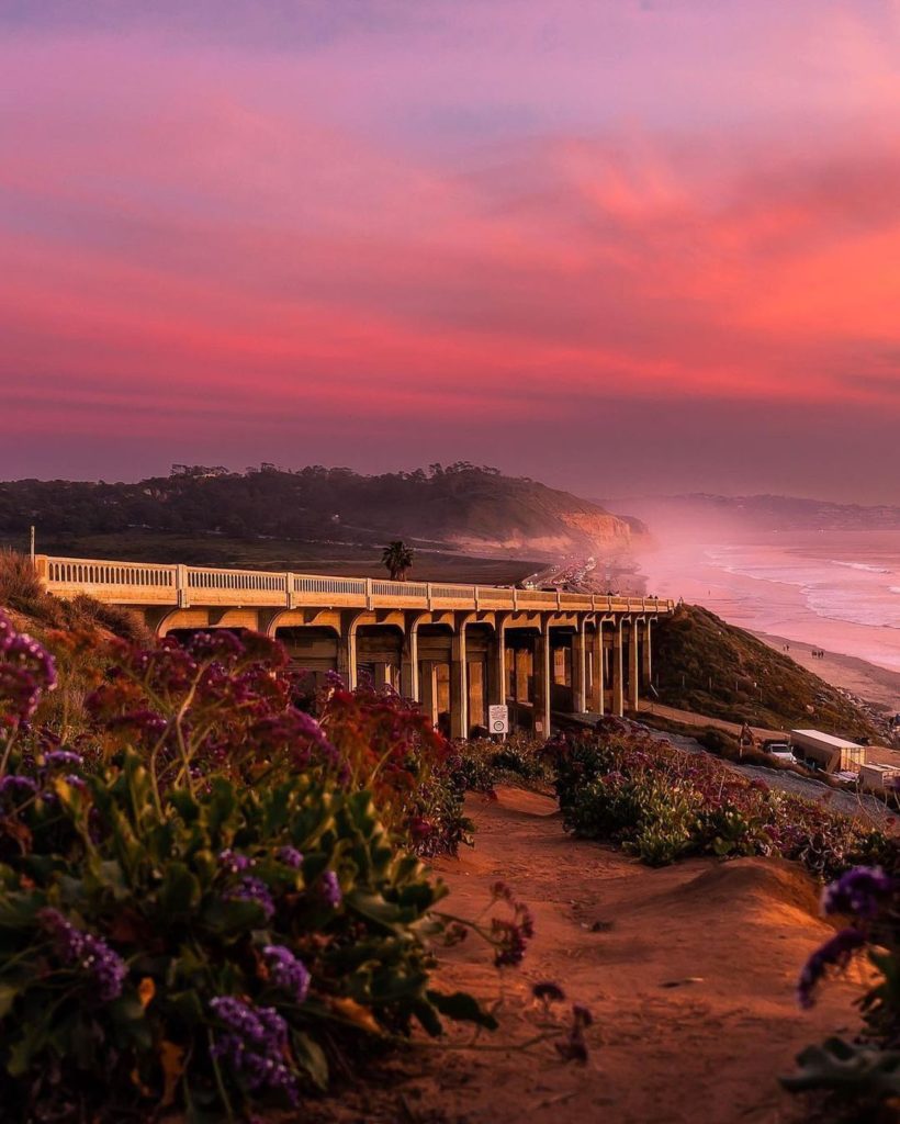 Scenic Drive along Pacific Ocean Coast with orange skies