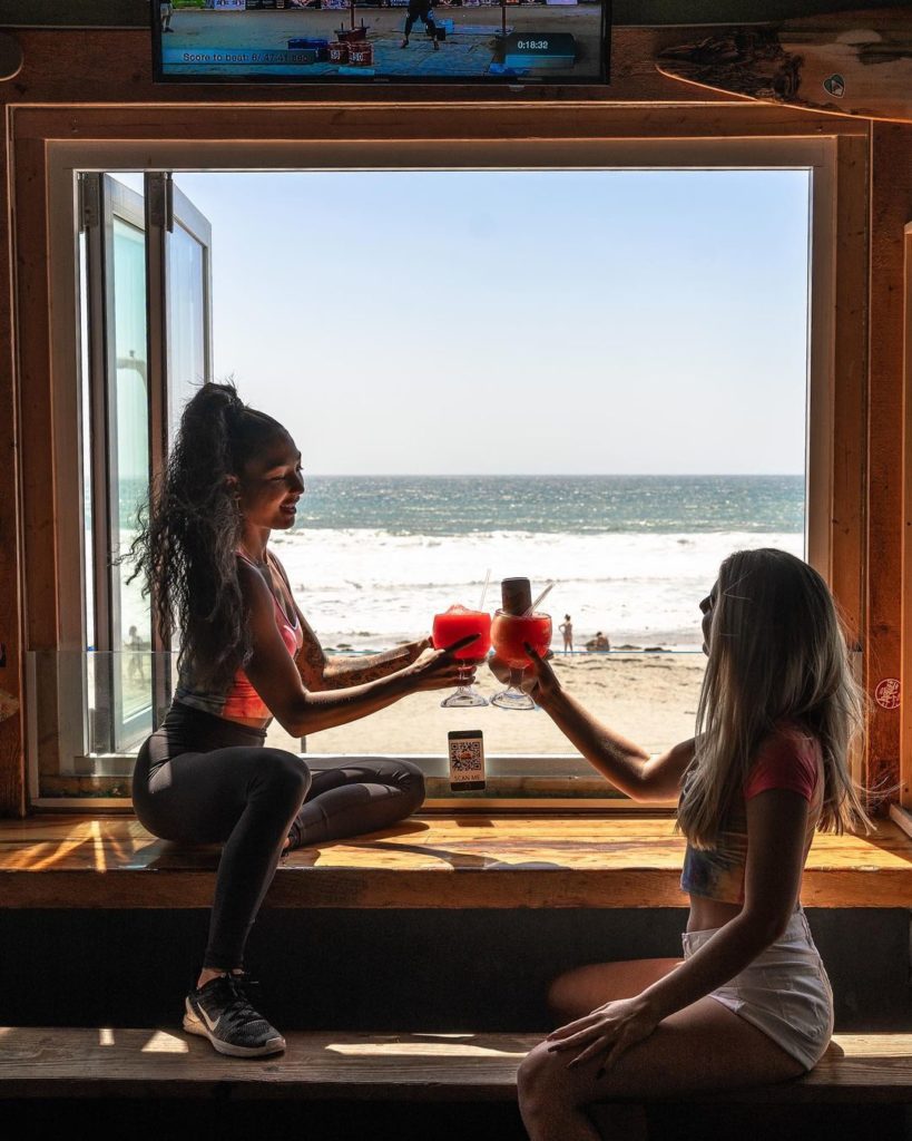 A couple of Girls enjoying drinks at pacific beach in San Diego