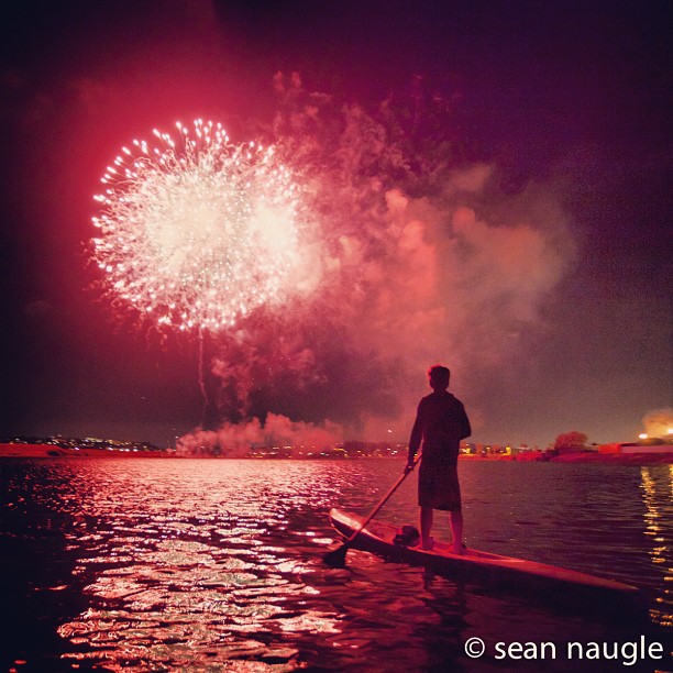 Paddleboarder on water during fireworks - 2024 San Diego events