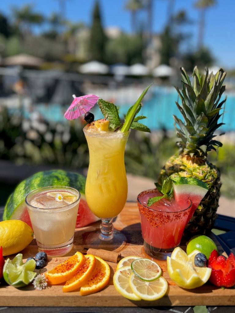 three spring cocktails overlooking the pool